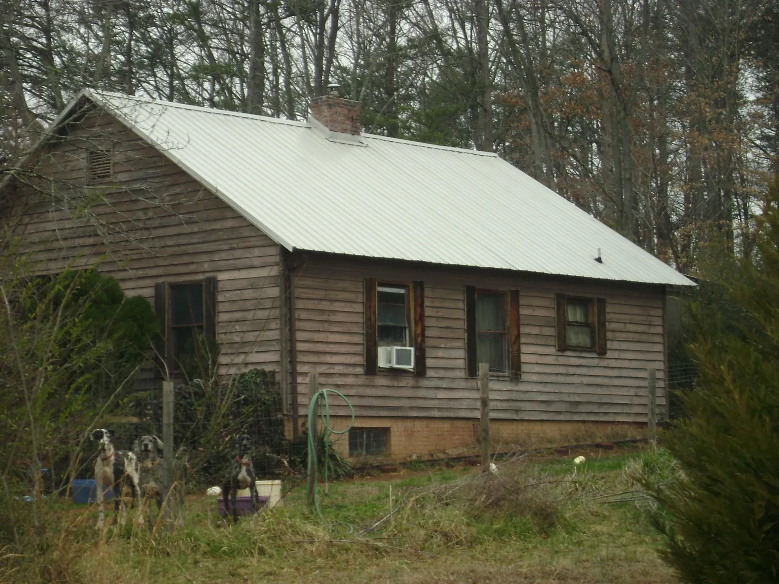 White metal roof on an old wood sided farmhouse, from a Metal Roof Installation job in North Canton
